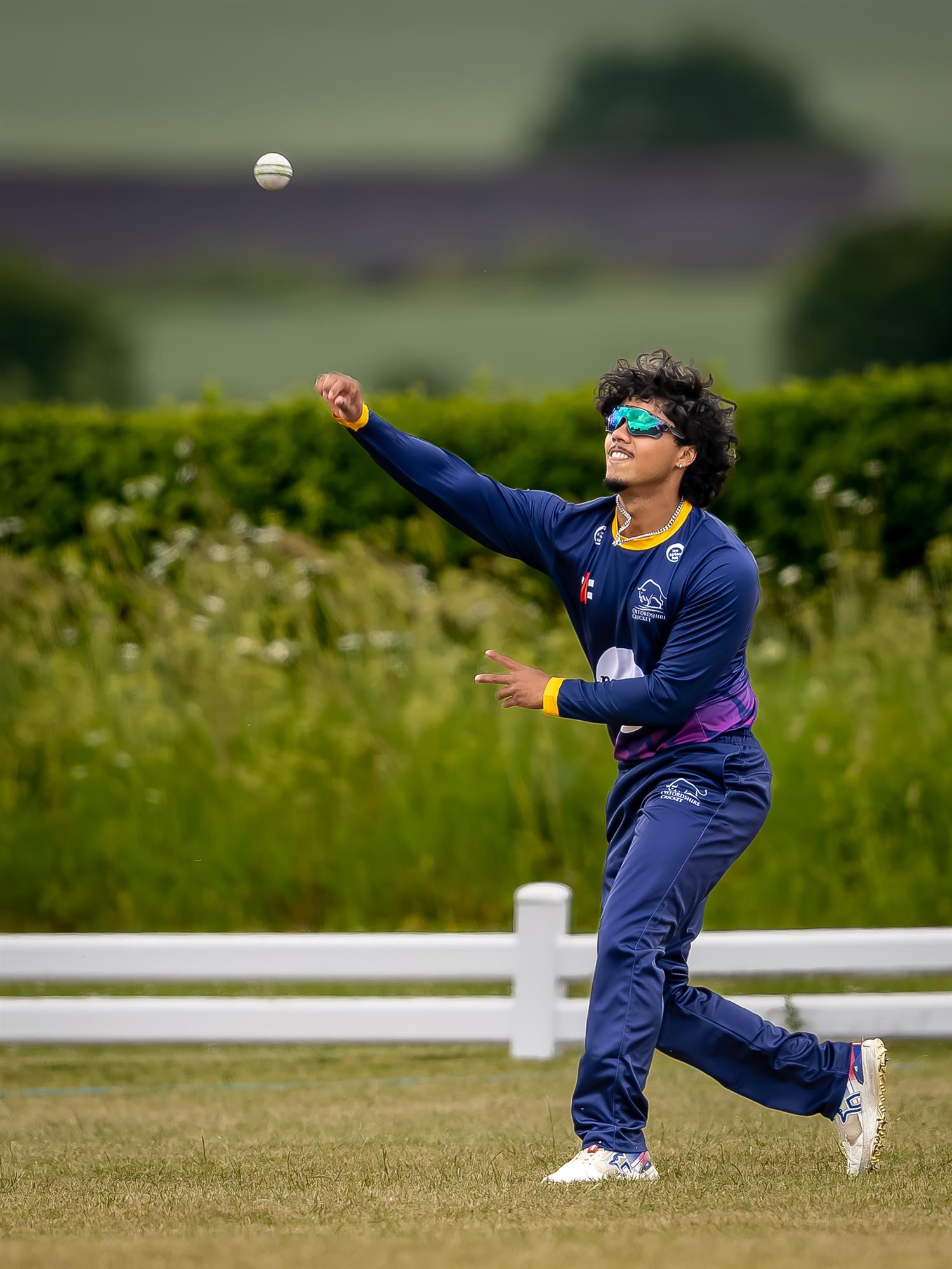 Oxfordshire's Nikhil Nair fielding the ball on the boundary in the first of two NCCA Dojo T20 matches against Wales NC at Challow & Childrey Cricket Club on May 31st, 2026. 