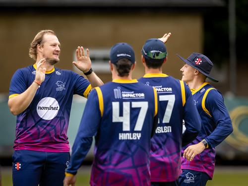 Oxfordshire's Hayden Rossouw (left) is congratulated by team mates after taking two wickets in two balls during the NCCA NV Play Trophy Quarter Final against Wiltshire at Warminster Cricket Club on June 7th, 2026.