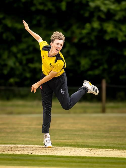 Hertfordshire's Tom Arnold bowling in the first of two NCCA Dojo T20 matches against Suffolk at Mellis Cricket Club on July 5th, 2026. 