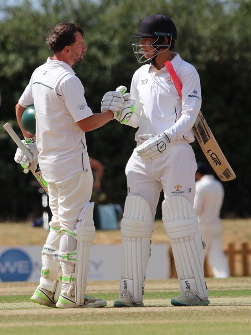 Hertfordshire v Lincolnshire, NCCA Cluberly Eastern Div 2 match, held at Lucas Lane on 26/07/2026 .
Sam Evans reaches his century for Lincolnshire C.C.C. and is congratulated by Sam Jarvis. The pair shared a second wicket stand of 226 runs, breaking a one hundred year old record against Hertfordshire, previously held by Bashforth and Frearson, 181 runs at Grimsby in 1926.
Paul Pollard and Martyn Dobson still hold the record highest ever 2nd wicket stand for Lincolnshire against all opposition of 331 runs v Northumberland at Grantham in 2003.